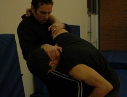 Knee strike to stomach whilst grappling (b)