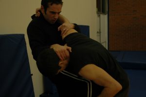 Knee strike to stomach whilst grappling (b)